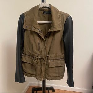 Army green jacket with leather sleeves and zippers on sleeves